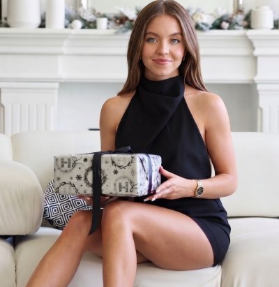 Sydney Sweeney in black halter top in a bright home interior